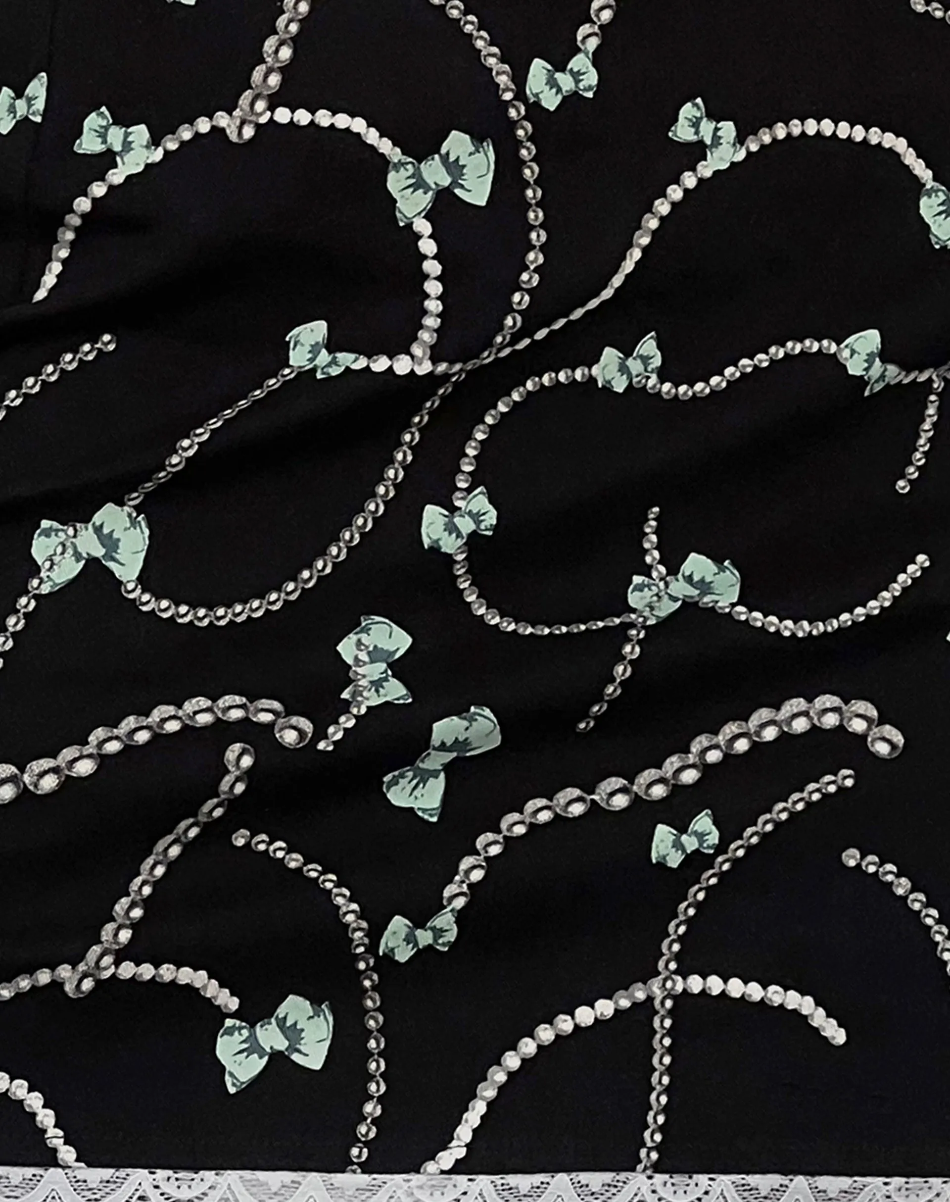 Molen Mini Skirt in Black with Pearl and Bow Print